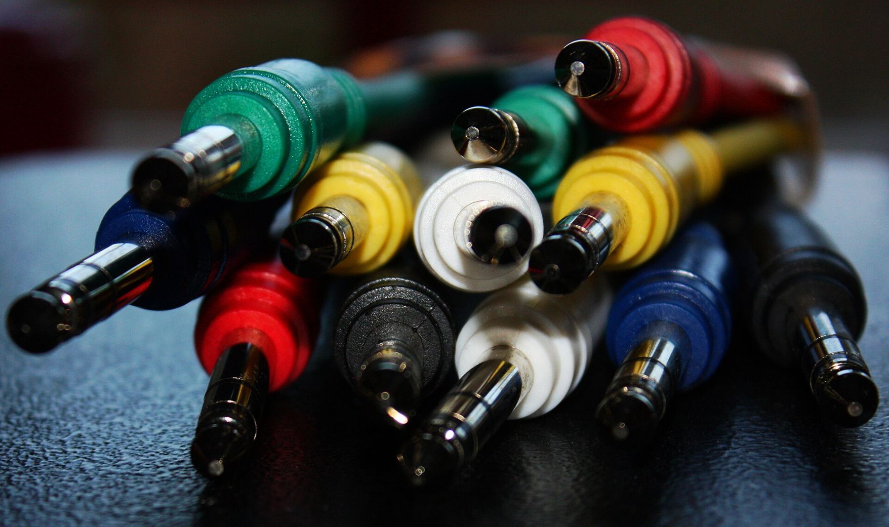 A colourful bundle of patch cables with metal jack plugs