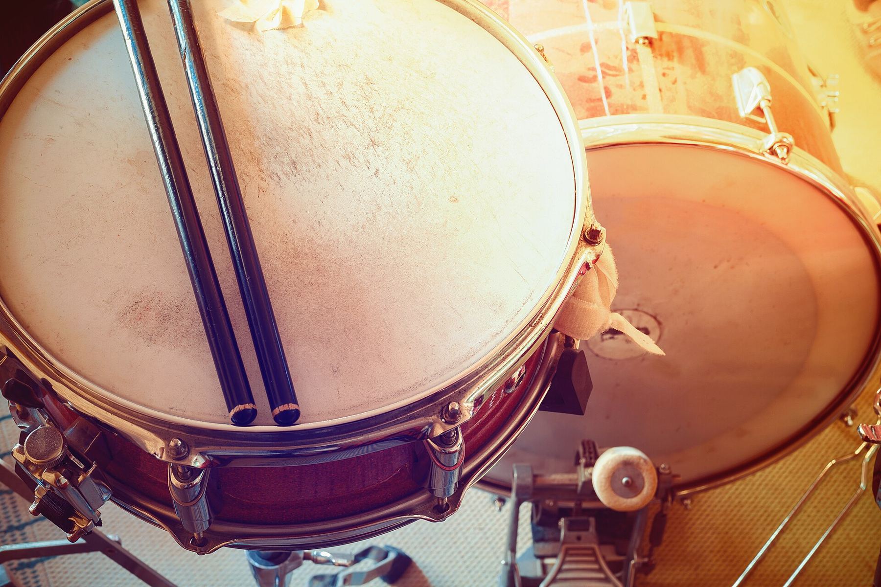 Close-up of a snare drum with drumsticks resting on the head