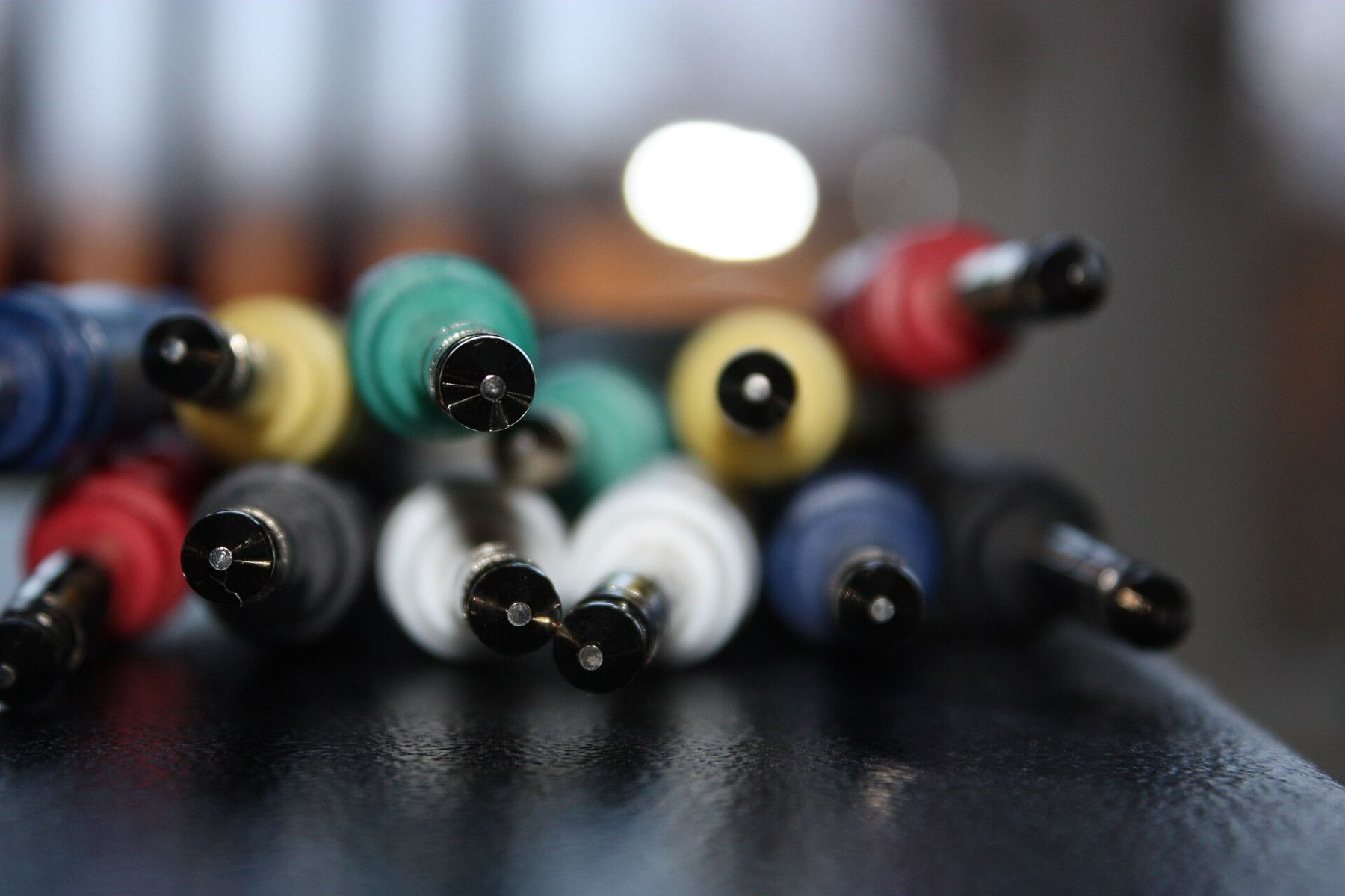 A close-up of coloured cable plugs bundled together