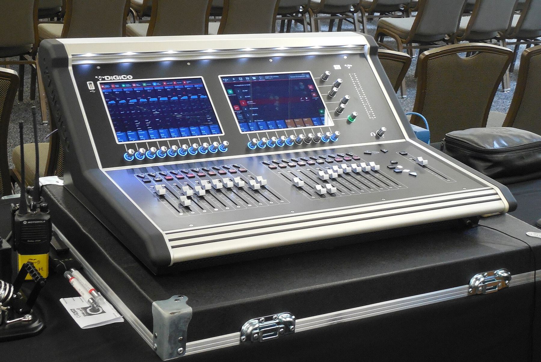 A digital mixing console with two touchscreens in a road case