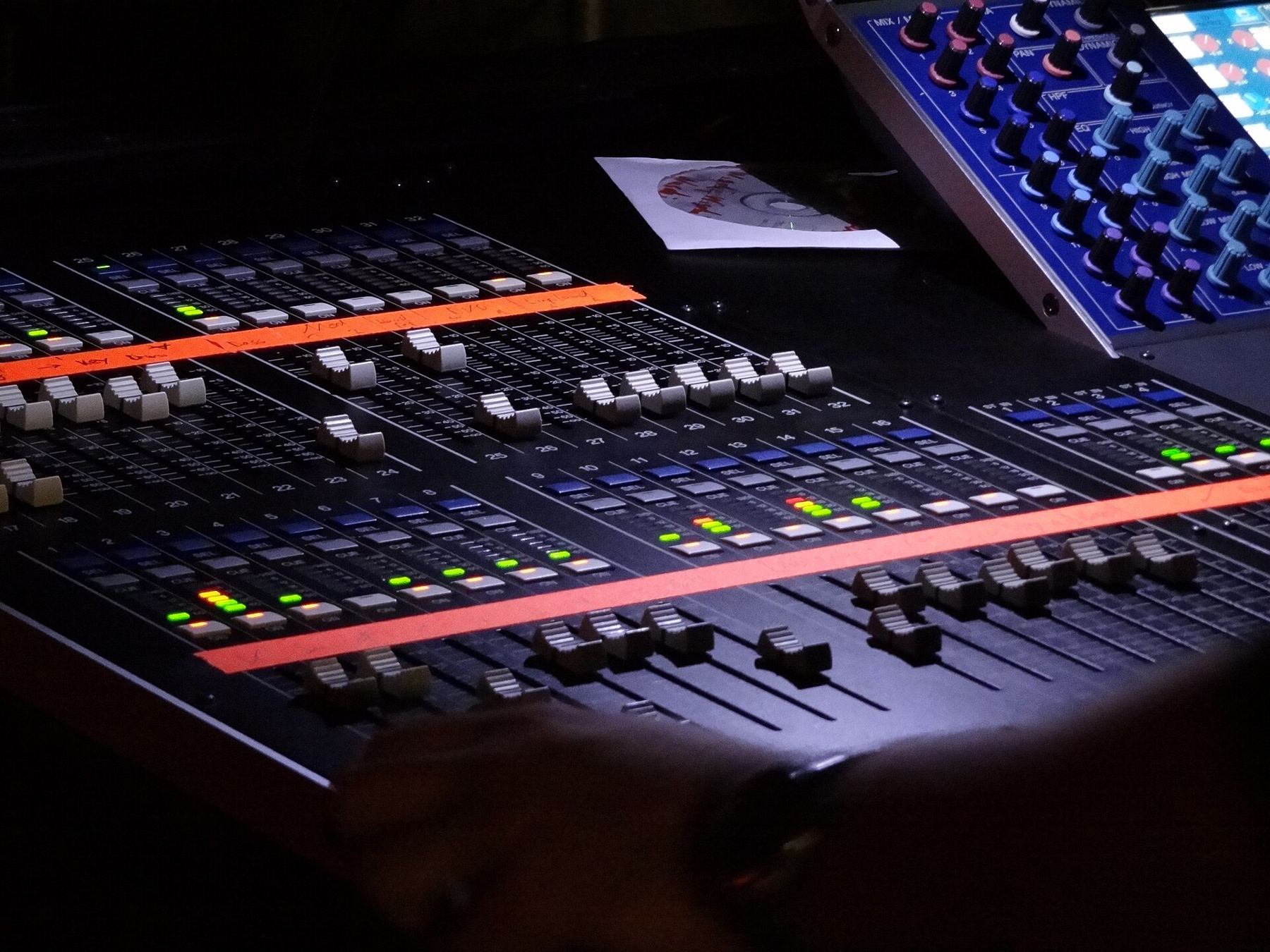 Close-up of illuminated faders on a mixing console